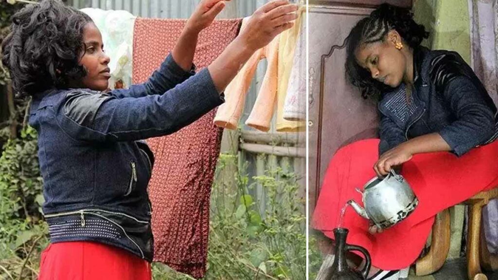 This image shows two scenes of Muluwork engaged in daily activities. On the left, she is seen hanging laundry outdoors, wearing a dark jacket and a vibrant red skirt, surrounded by greenery. On the right, Muluwork sits indoors, also dressed in a dark jacket and red skirt, pouring water from a kettle. These moments capture her everyday life, highlighting her active and self-reliant lifestyle despite her claim of living without food or water for 16 years.