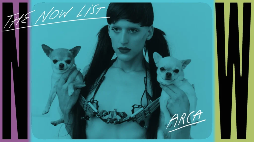 Arca is featured in a stylized promotional image with a blue color overlay, holding two small chihuahuas, one in each hand. She wears a bold, strappy outfit that highlights her avant-garde fashion sense, with her hair styled in sleek, high pigtails. Her striking makeup features dark lipstick, emphasizing her dramatic expression. The background displays the text "The Now List" and "Arca" in handwritten-style font, framed by large "N" and "W" letters on the sides, creating a dynamic and edgy visual composition.