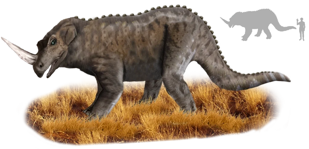 A digitally rendered depiction of a quadrupedal creature with a large forward-facing horn, a muscular reptilian body, a long crocodilian tail, and dark brown, scaly skin, standing on dry grass.