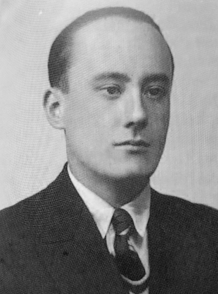 Formal black and white portrait of a young Daniel Guérin in a suit and tie, facing slightly left with a serious expression.